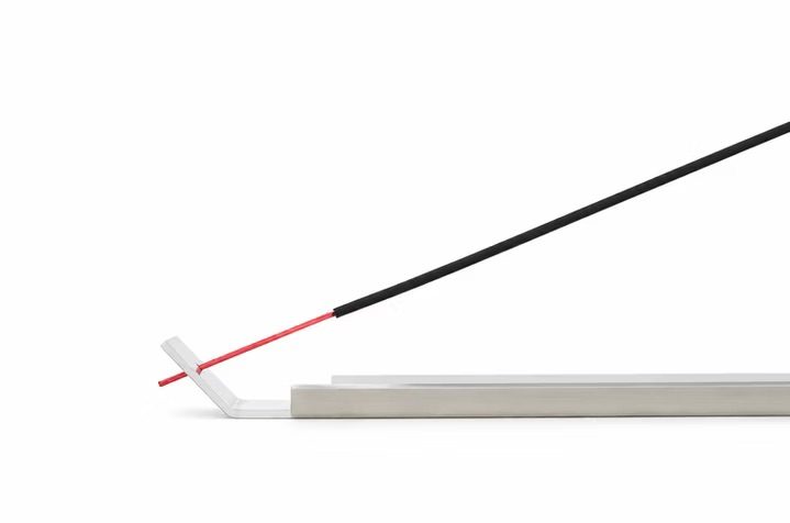 IH-01 incense holder with a lit incense stick, ember glowing red