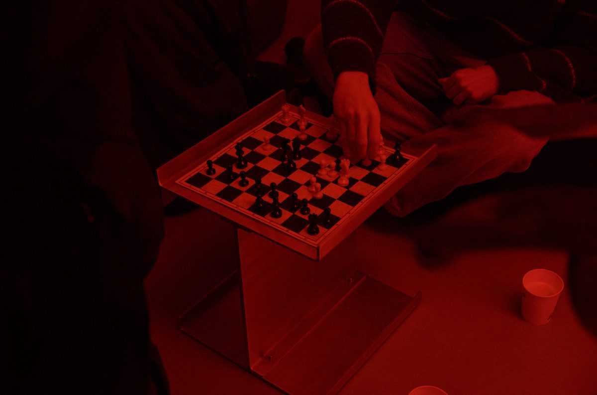 Modular Chair used as a small chess table, lit by a deep red light