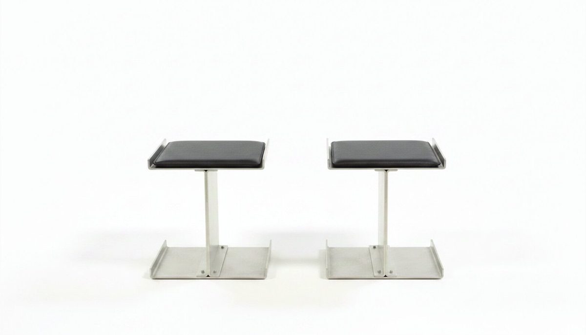Two Modular Chairs side by side, identical structure, brushed steel and black leather